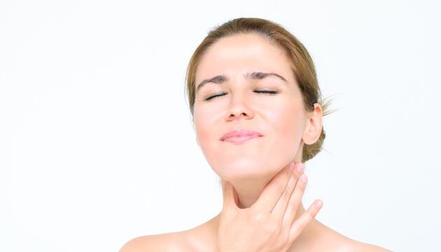 mujer con dolor en las cuerdas vocales